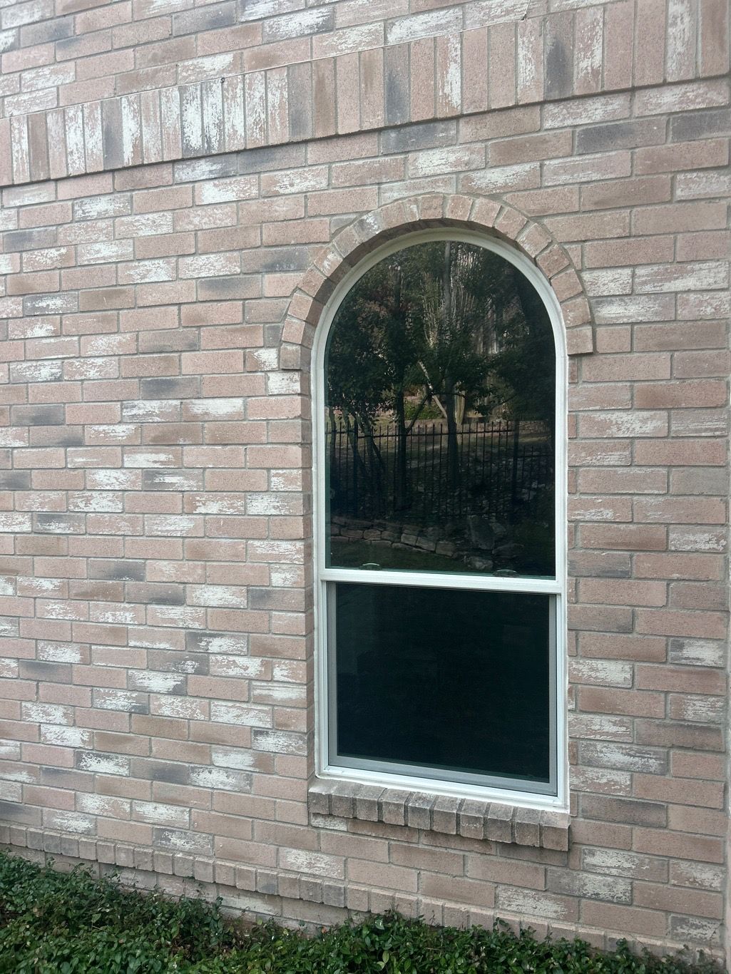 Anlin Panoramic single-hung arch-top window white frame red brick home Austin TX after installation by Glacier Home Exteriors