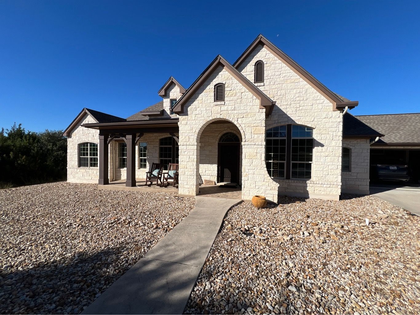 Old failing aluminum windows with grids before Anlin replacement on stone Hill Country home Dripping Springs TX by Glacier Home Exteriors