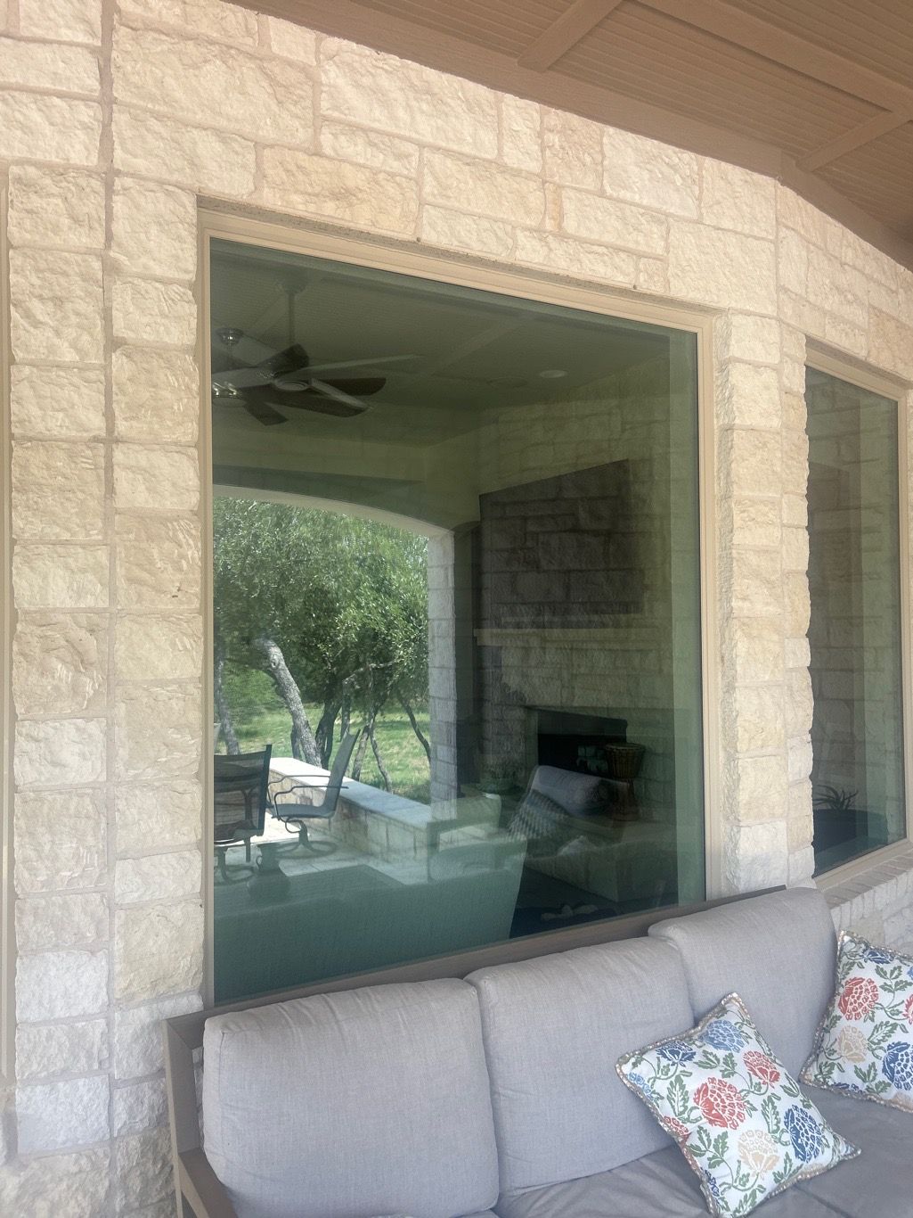 Anlin Panoramic window exterior view on luxury stone home Round Rock TX by Glacier Home Exteriors