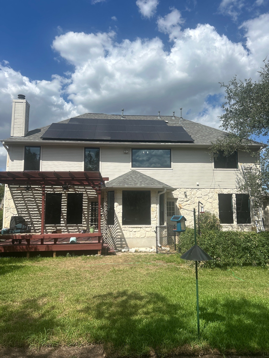 Anlin window replacement back elevation 2-story home dark frames solar panels Round Rock TX by Glacier Home Exteriors